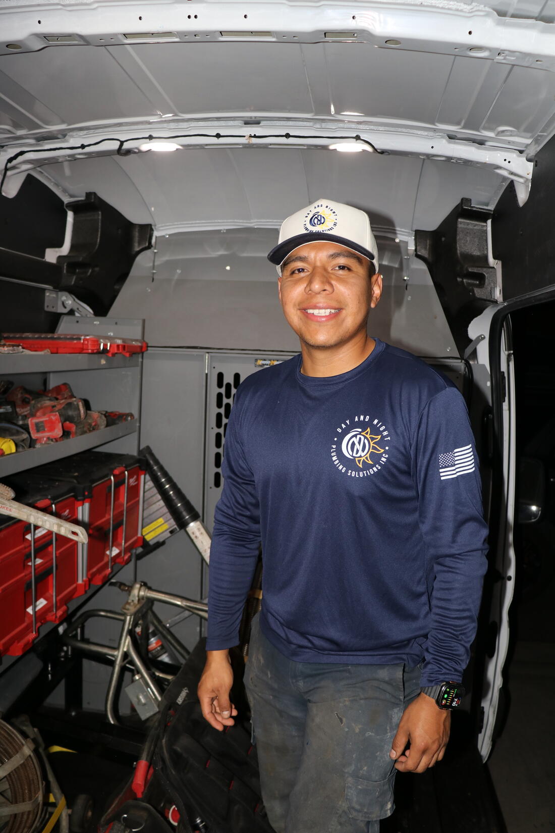 The owner of Day and Night Plumbing Solutions with his service van