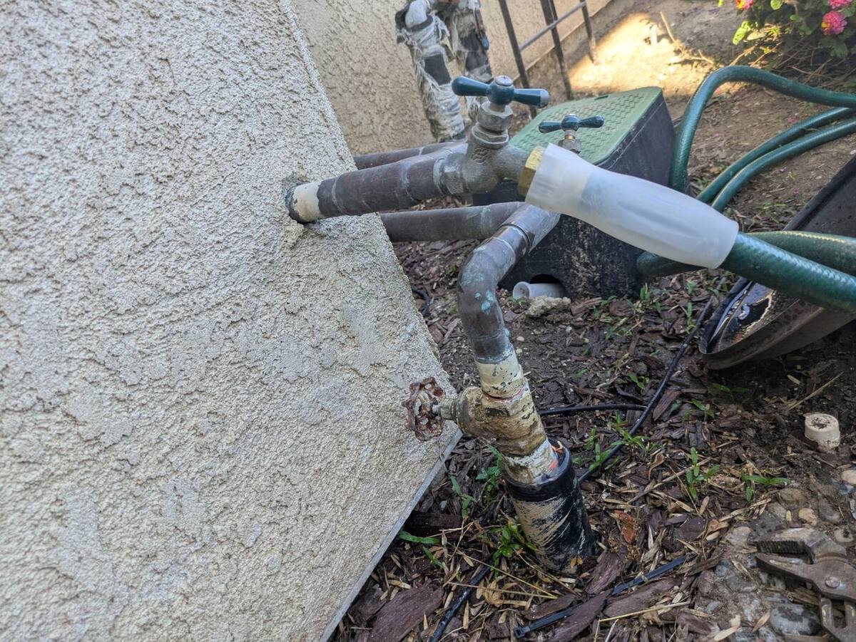 Old corroded gate valve with a rusted wheel handle on a Bakersfield main water line